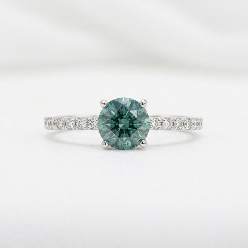 Teal sapphire diamond pave band ring on white background